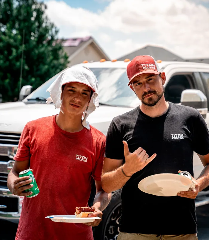 Two Titan crew members at a job-site cookout