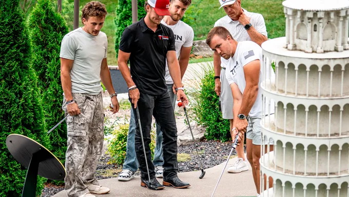 Titan Roofing team members out together playing mini golf