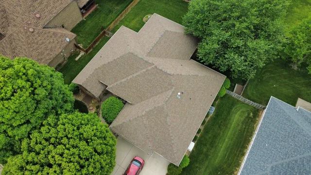 Aerial view of a home with a new brown architectural shingle roof