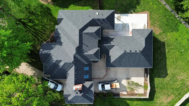 Aerial view of a large home with a new charcoal architectural shingle roof