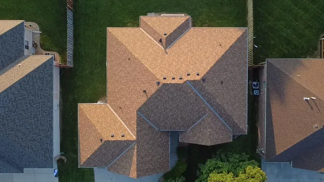 Aerial view of a home with a new sand-toned architectural shingle roof
