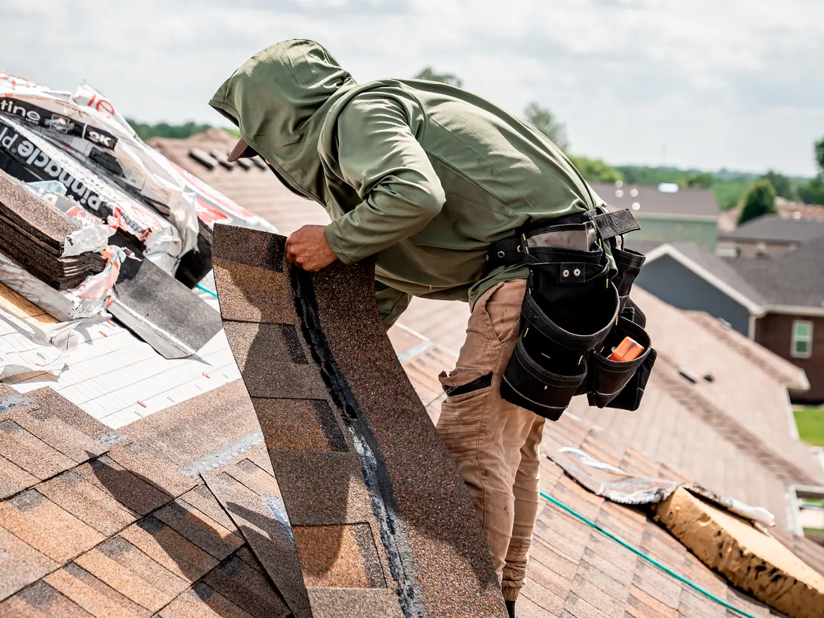 Roofer installing new architectural shingles