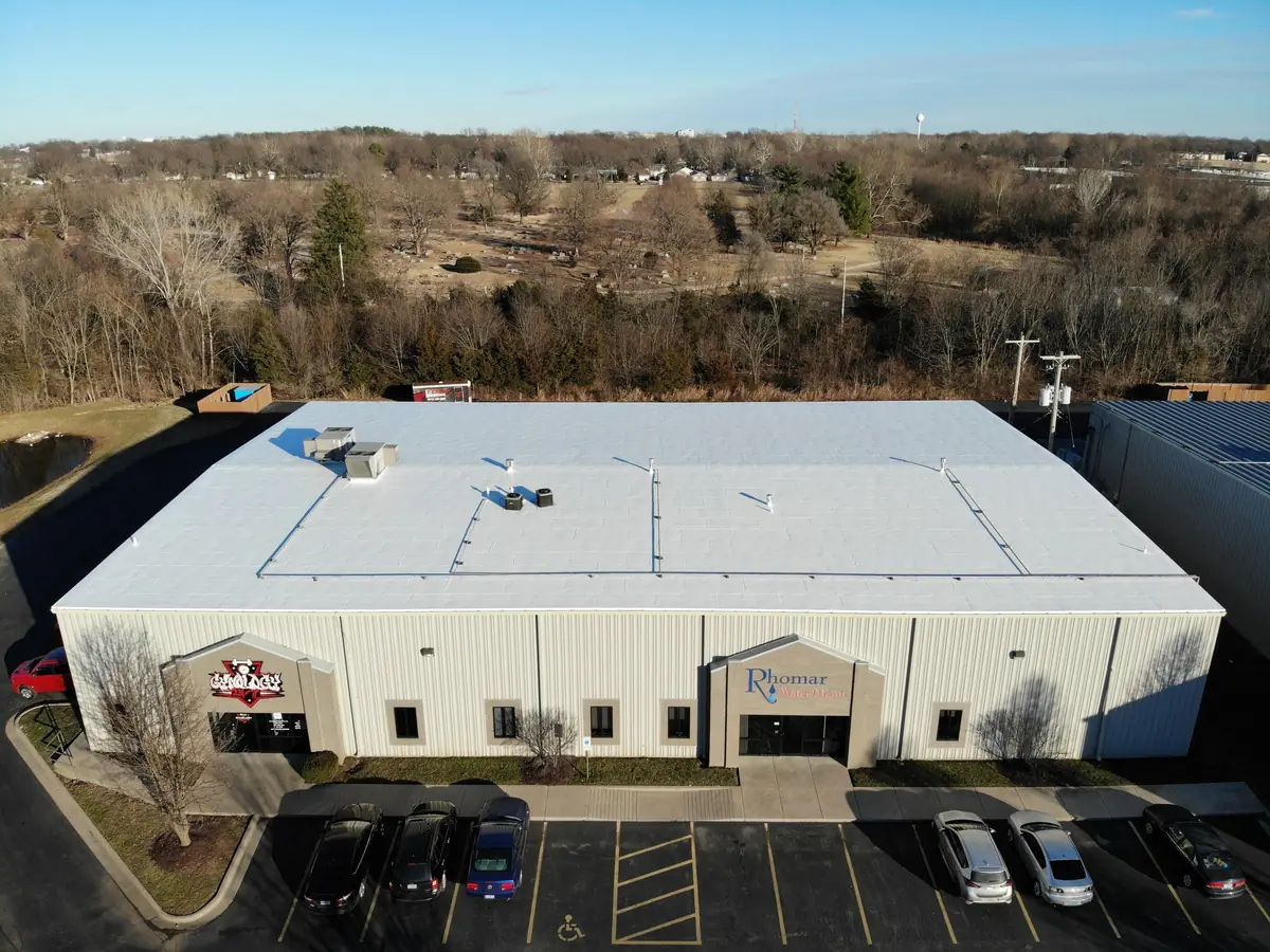 Large commercial building with a white membrane roof, seen from above