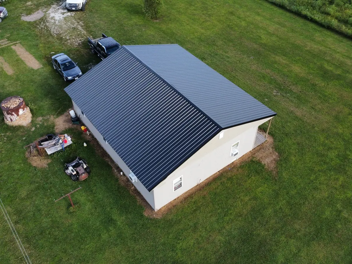 Shop building with a new dark metal roof, seen from above