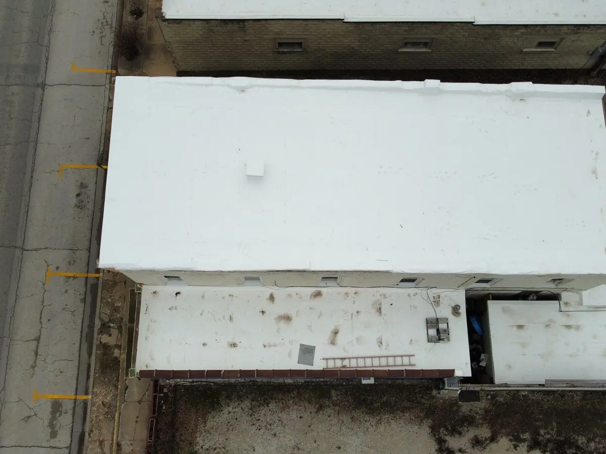 Commercial building with a new white membrane roof, seen from directly above