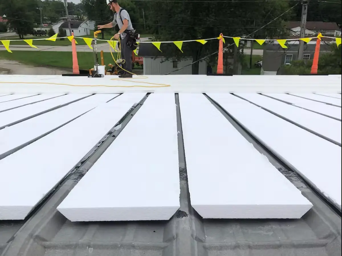 Titan crew working on a white ribbed PVC membrane roof