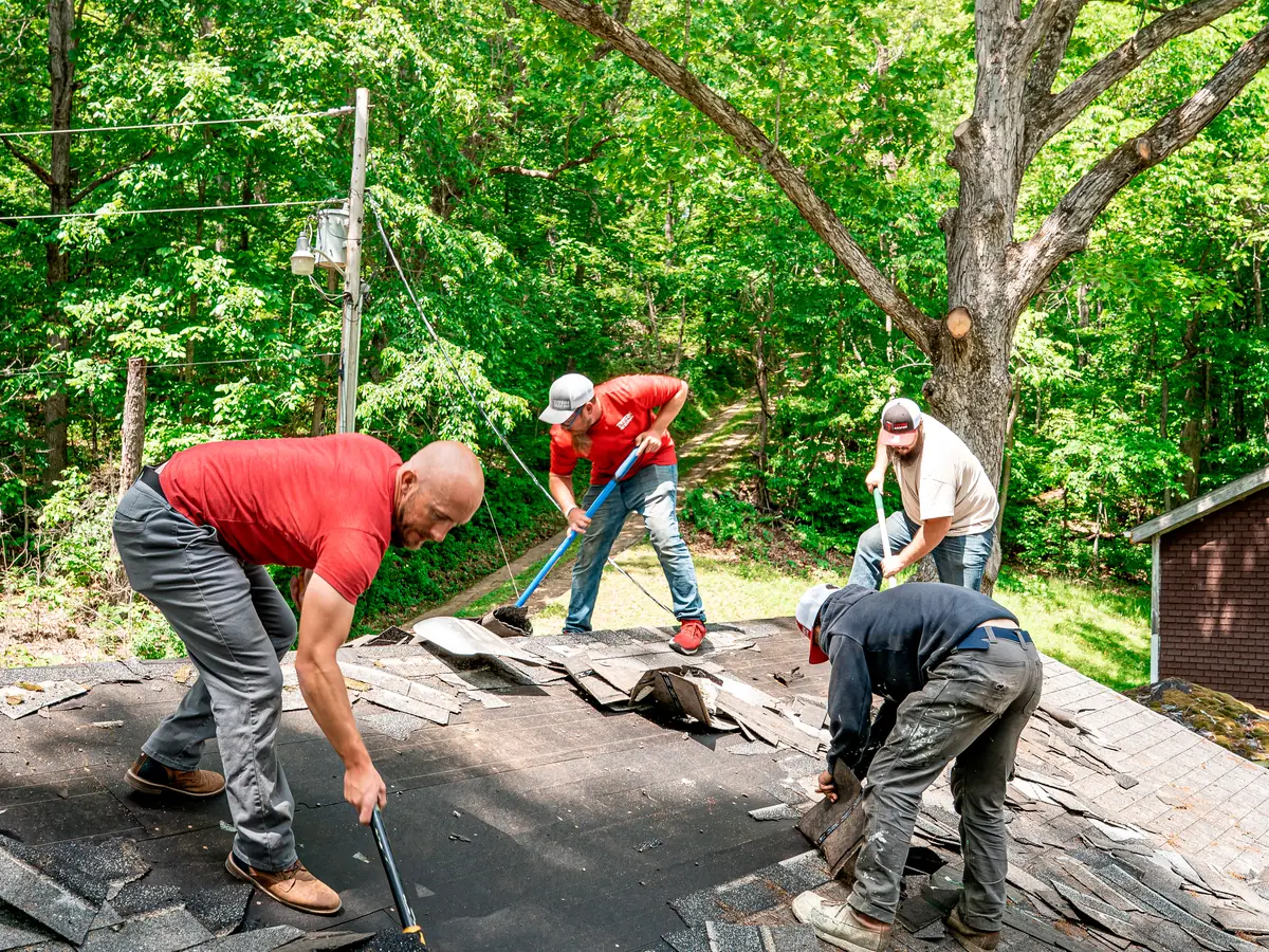 Titan Roofing crew tearing off old shingles during a roof replacement