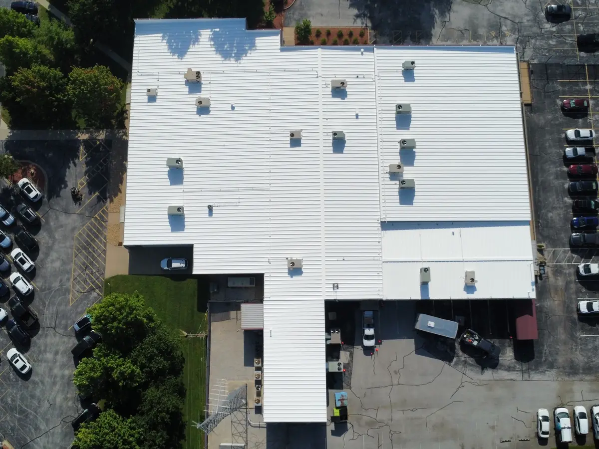 Finished white coated commercial roof with rooftop units, seen from above