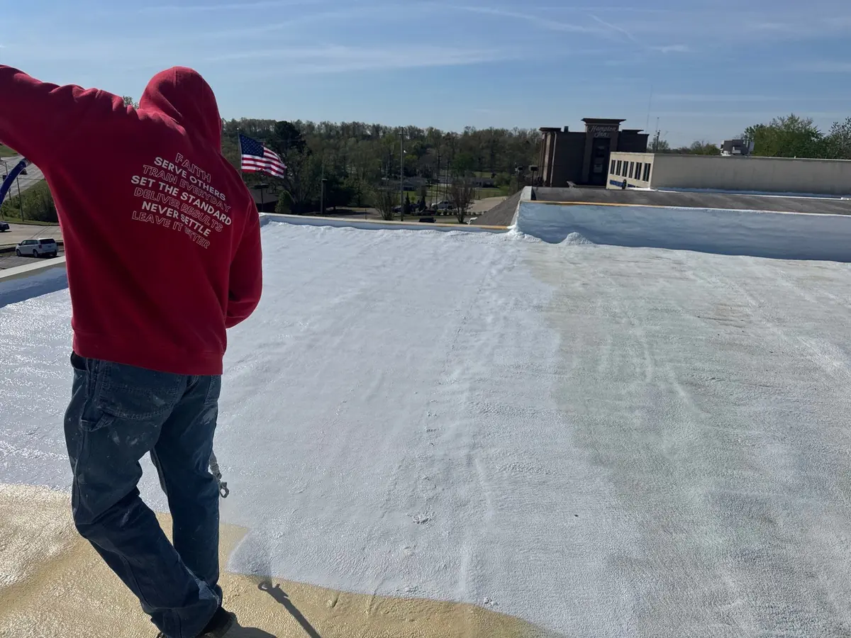 Titan crew member looking over a finished spray foam roof