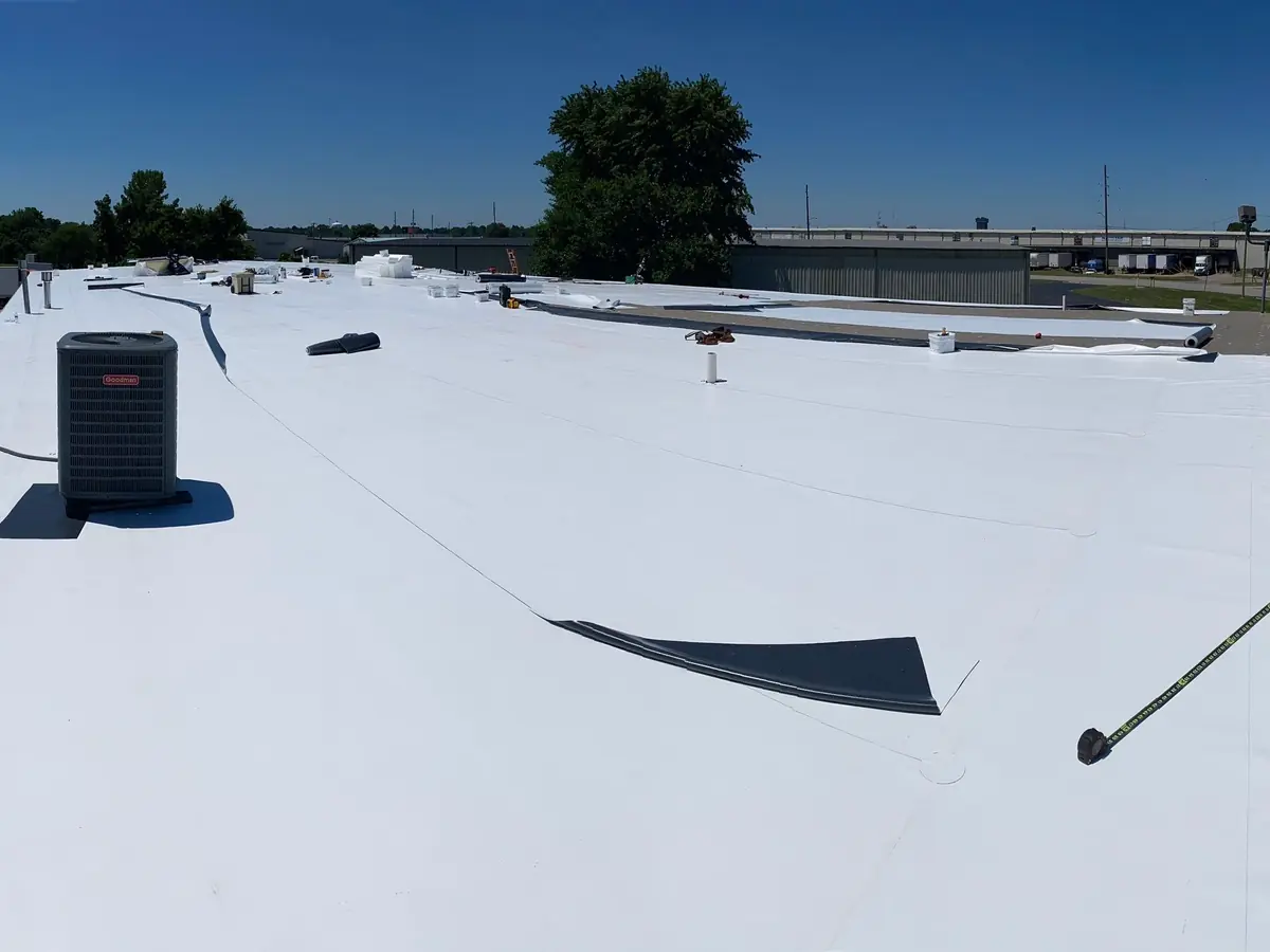 White single-ply membrane roof with a rooftop unit up close