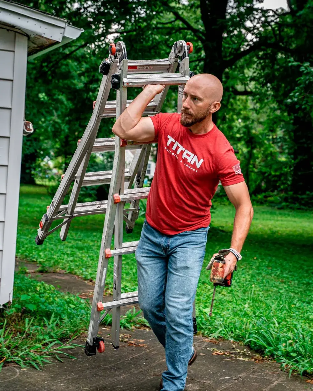 Titan inspector carrying a ladder to a home for a free roof inspection