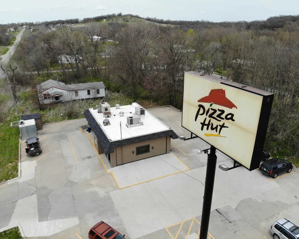Pizza Hut restaurant with a new white flat roof