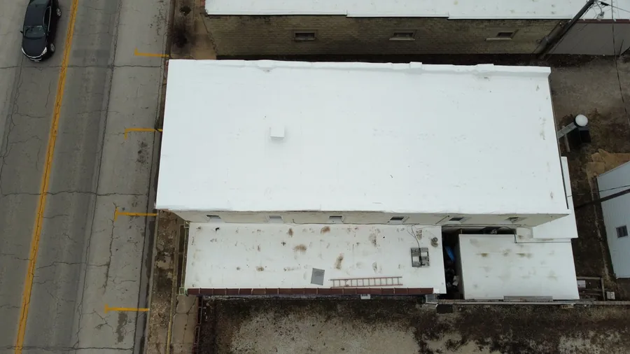 Downtown commercial building with a fresh white membrane roof
