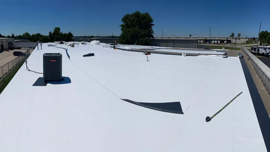 New single-ply membrane roof with rooftop unit and walkway