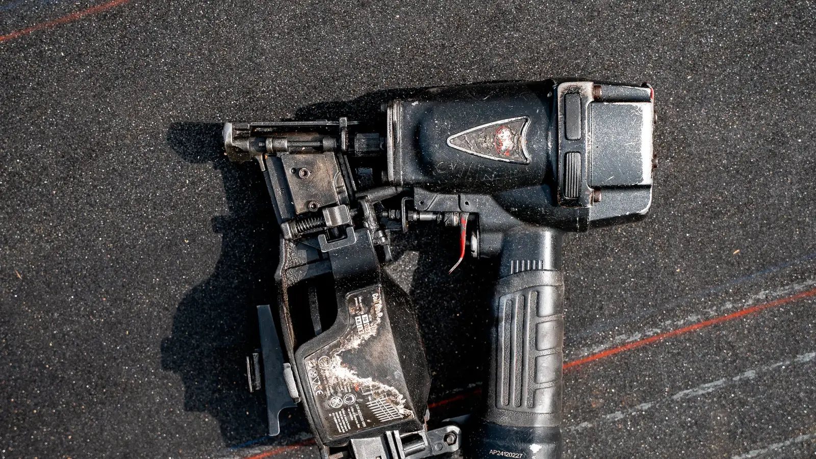 Pneumatic roofing nailer and air hose on underlayment
