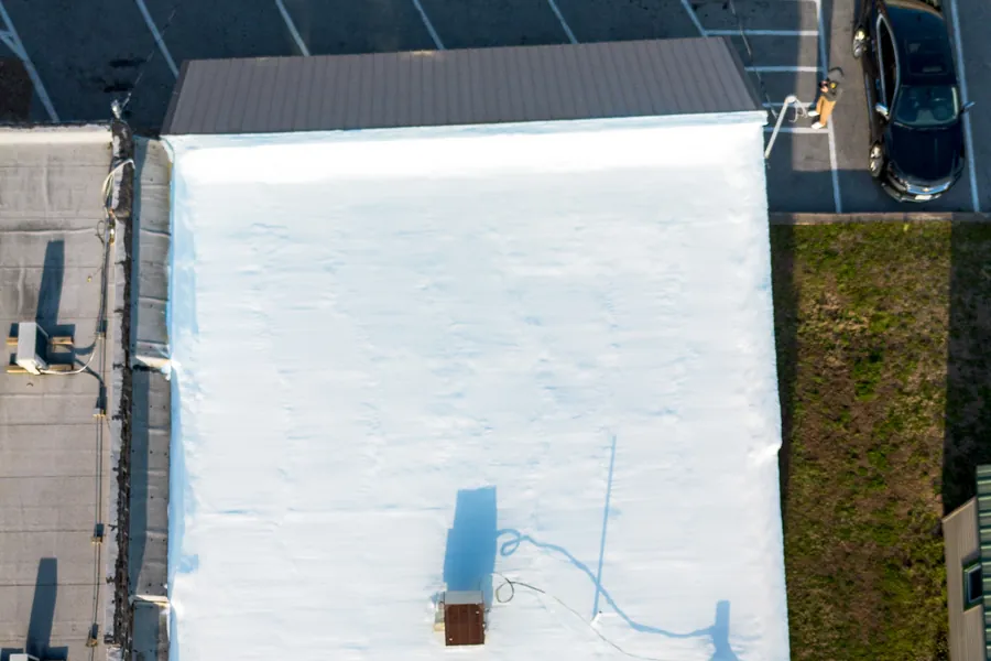 Commercial building with a new white membrane roof, seen from above