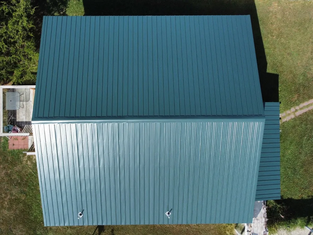 Evergreen exposed fastener metal roof panels on a Missouri home, seen straight down from a drone