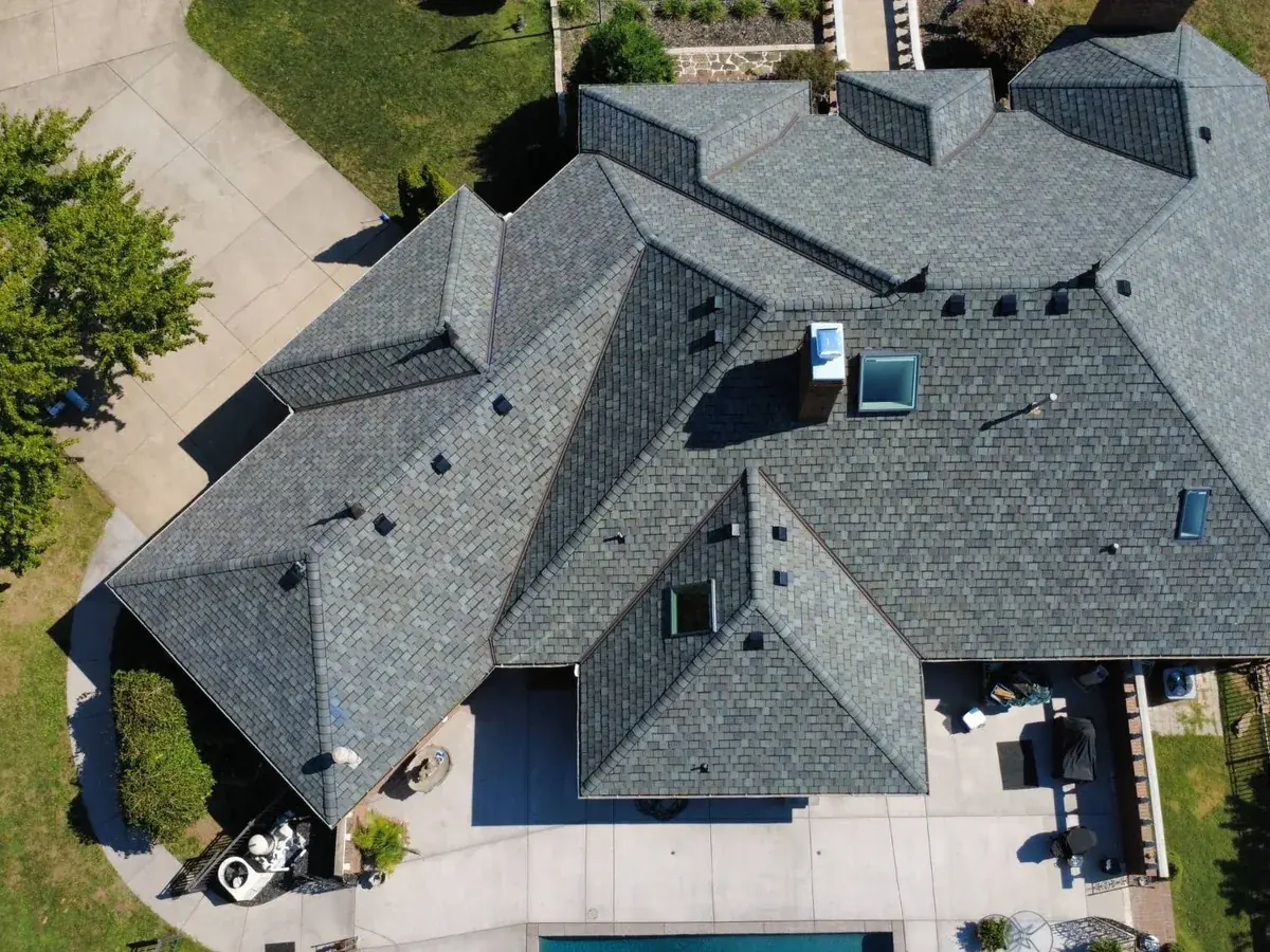 Drone view of a home with a new premium shake-style designer shingle roof installed by Titan Roofing