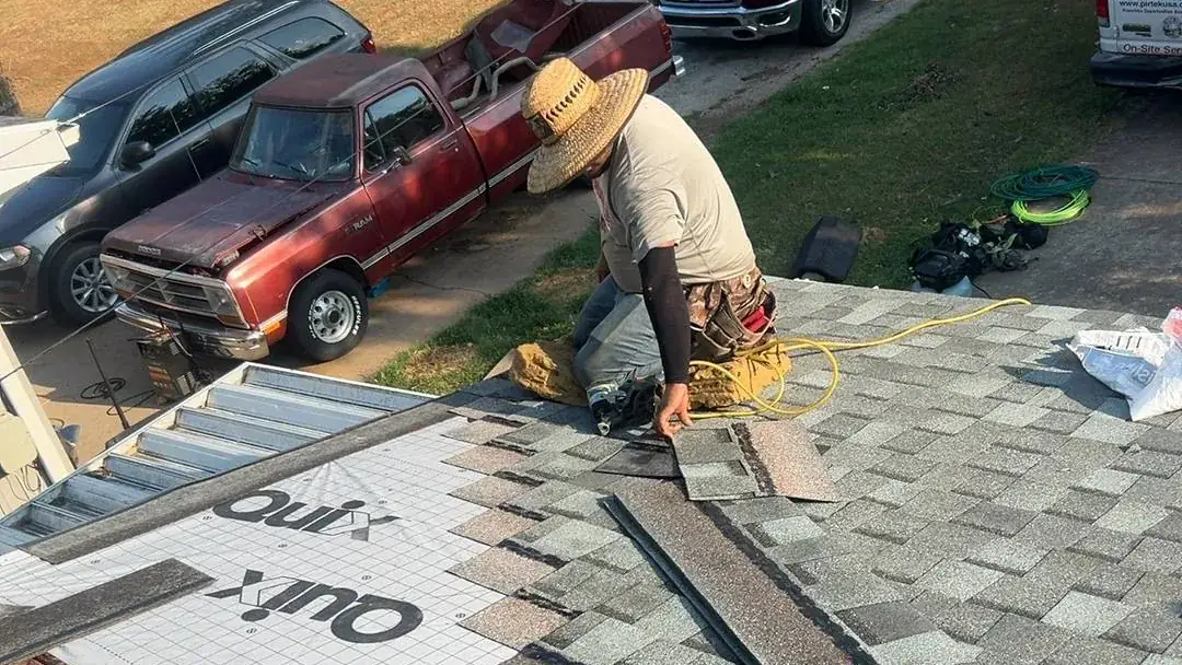 Titan roofer installing architectural shingles over new underlayment on a Springfield home