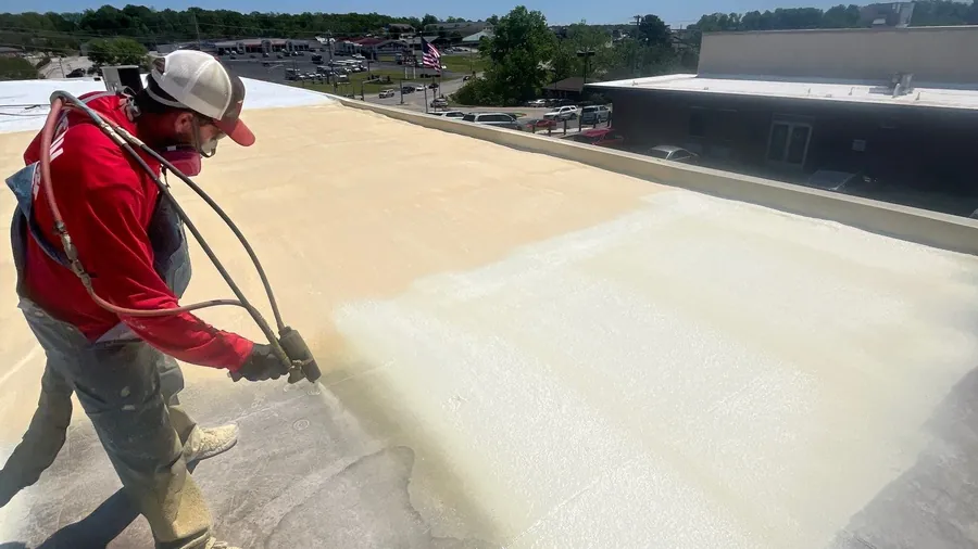 Spray foam being applied to a commercial roof