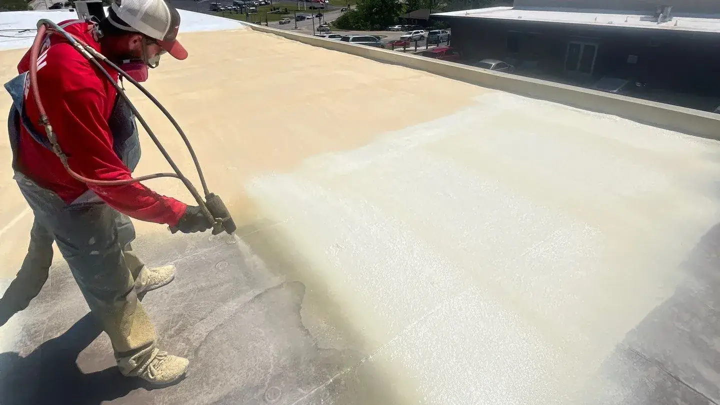 Titan crew spray-applying foam roofing on a commercial roof