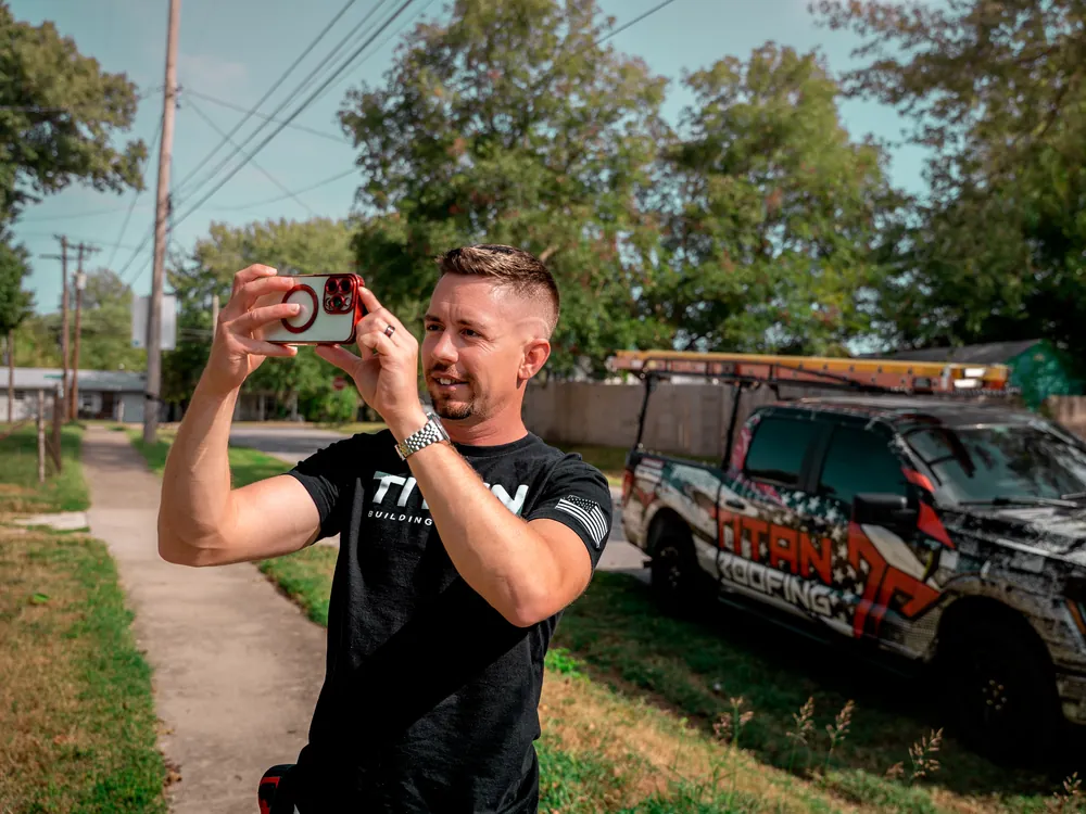 Titan inspector documenting storm damage on a roof