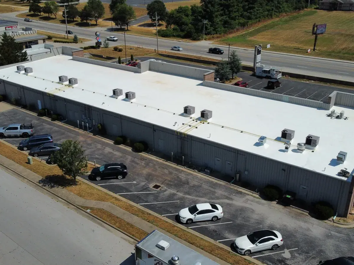Long commercial building with a new white TPO membrane roof