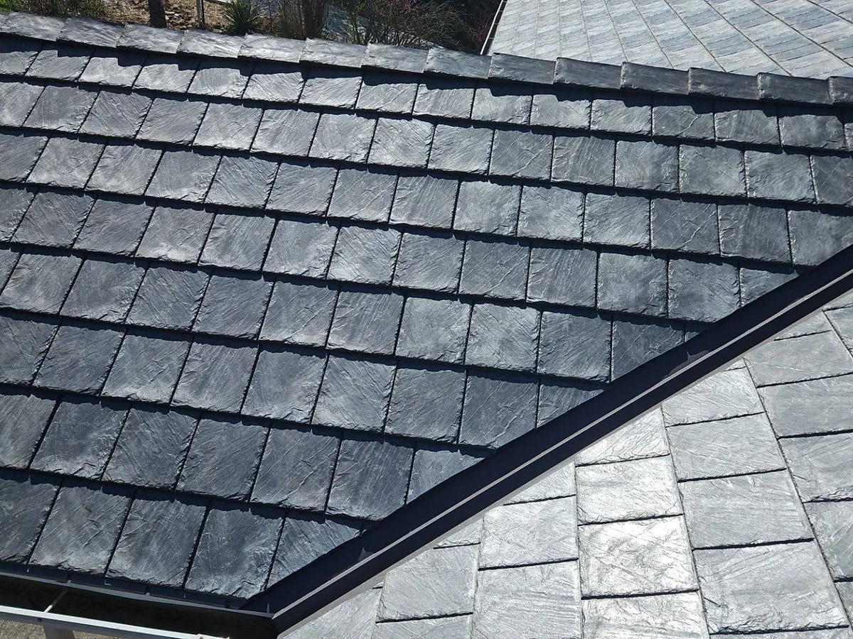 Synthetic slate meeting a metal valley on a Titan Roofing install