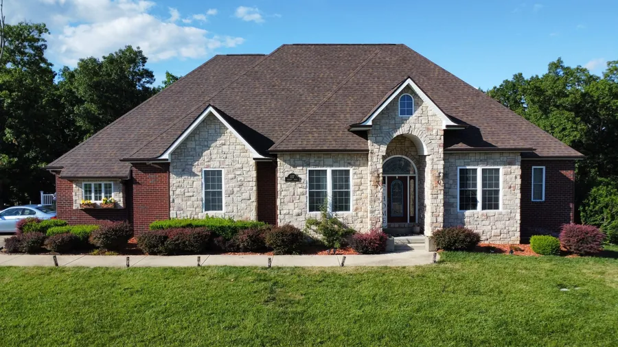 Stone-front Missouri home with a new brown architectural shingle roof