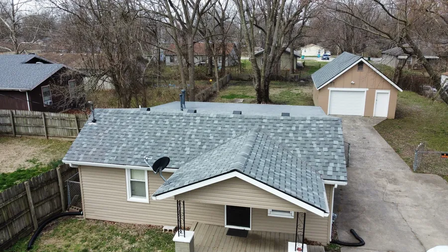 Ranch home with fresh tan siding and a new shingle roof