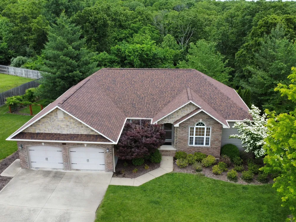 Brick home with a new brown architectural shingle roof, seen from above
